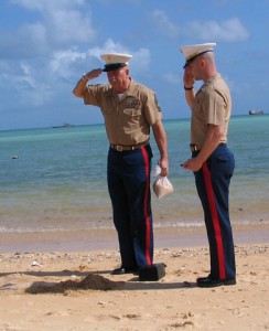  Master Sgt. James M. Fawcett, left and Capt. Kyle Corcoran salute Fawcett's father's ashes on Red Beach 1. MSgt Fawcett's father landed on Red 1 on 20 Nov 1943.