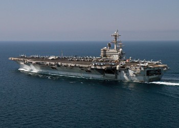 141010-N-AP620-012 ARABIAN GULF (Oct. 10, 2014) The aircraft carrier USS George H.W. Bush (CVN 77) prepares for a vertical replenishment with the amphibious assault ship USS Makin Island (LHD 8). George H.W. Bush is supporting maritime security operations, strike operations in Iraq and Syria as directed, and theater security cooperation efforts in the U.S. 5th Fleet area of responsibility. (U.S. Navy photo by Lt. Juan D. Guerra/Released)