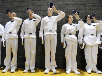 ANNAPOLIS, MD --6/30/11-Today is Induction Day at the United States Naval Academy for the Class of 2015. Plebes read the Reef Points booklet- things they need to learn this summer like ranks and the mission of the USNA- as they wait in line before going through the "courtesies and customs" training. That training includes standing at attention, saluting, and wearing the "dixie cup" head cover. {Photos by Sun Photographer, Algerina Perna} md-usna-induction-p1-perna