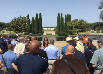 Veronica Stasio, Interpretive Guide of the Sicily-Rome American Cemetery, explains to the U.S. 6th Fleet staff the history of the cemetery and about the ground where more than 7,861 Americans are memorialized. VADM James Foggo III photo