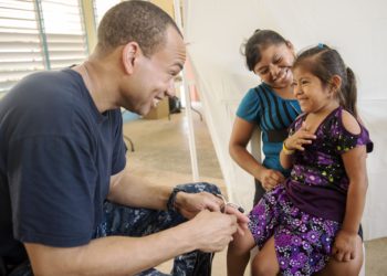  Lt. David Myles,performs an exam on a Belizean child at the Independence Polyclinic in Independence, Belize during Continuing Promise 2015. US Navy Photo