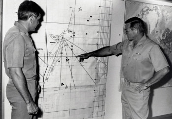 VADM Mustin discuses details of a fleet exercise in Norway with operations officer Captain Frank J. Lugo aboard USS Mount Whitey (LCC-20). Naval Institute Photo Archive.
